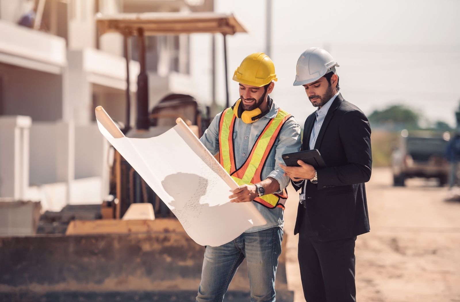 Engineers reviewing drawings and project data on site